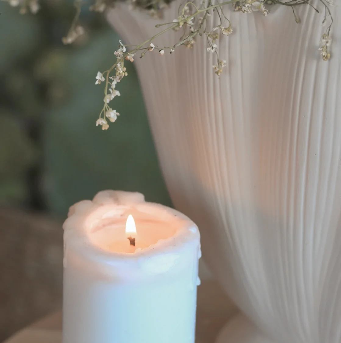 Lit candle and dried flowers creating a calm and relaxing space